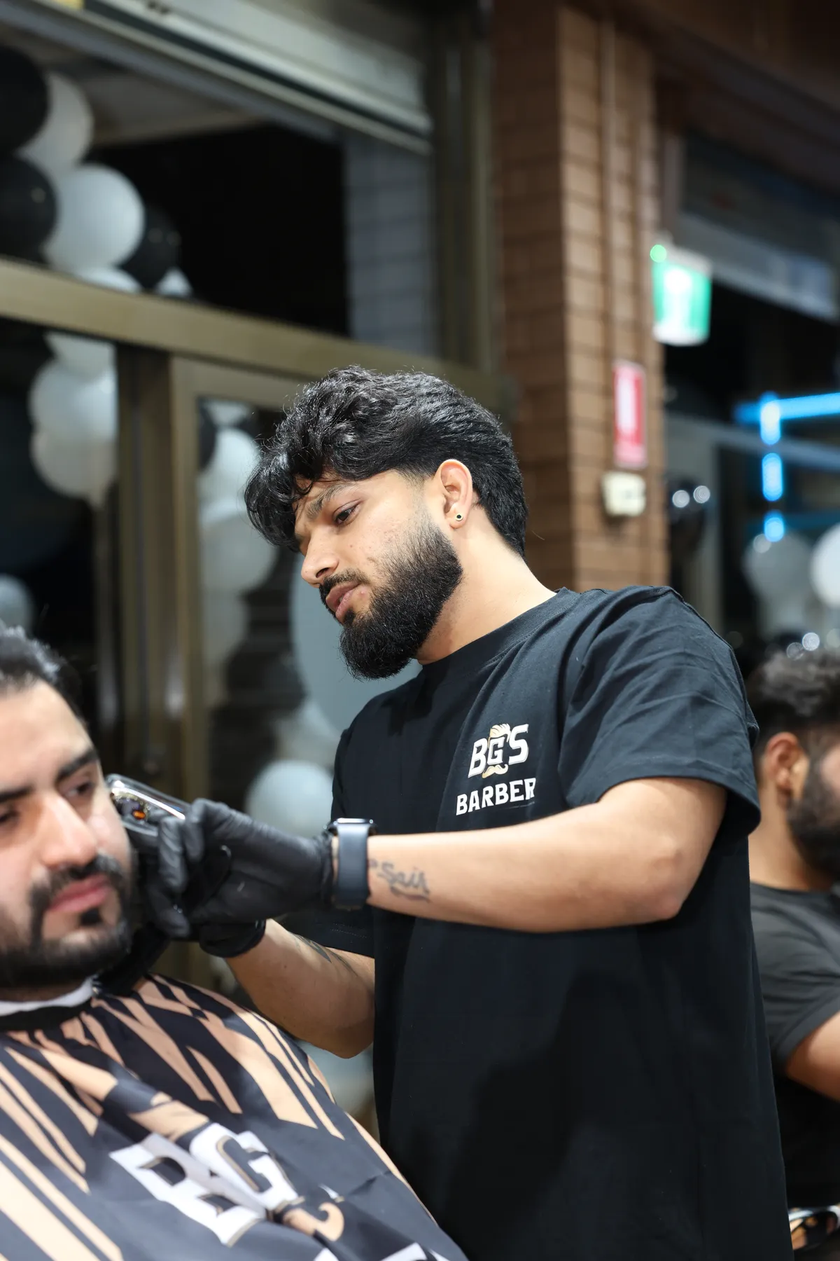 Close-up of an artist trimming a client's beard