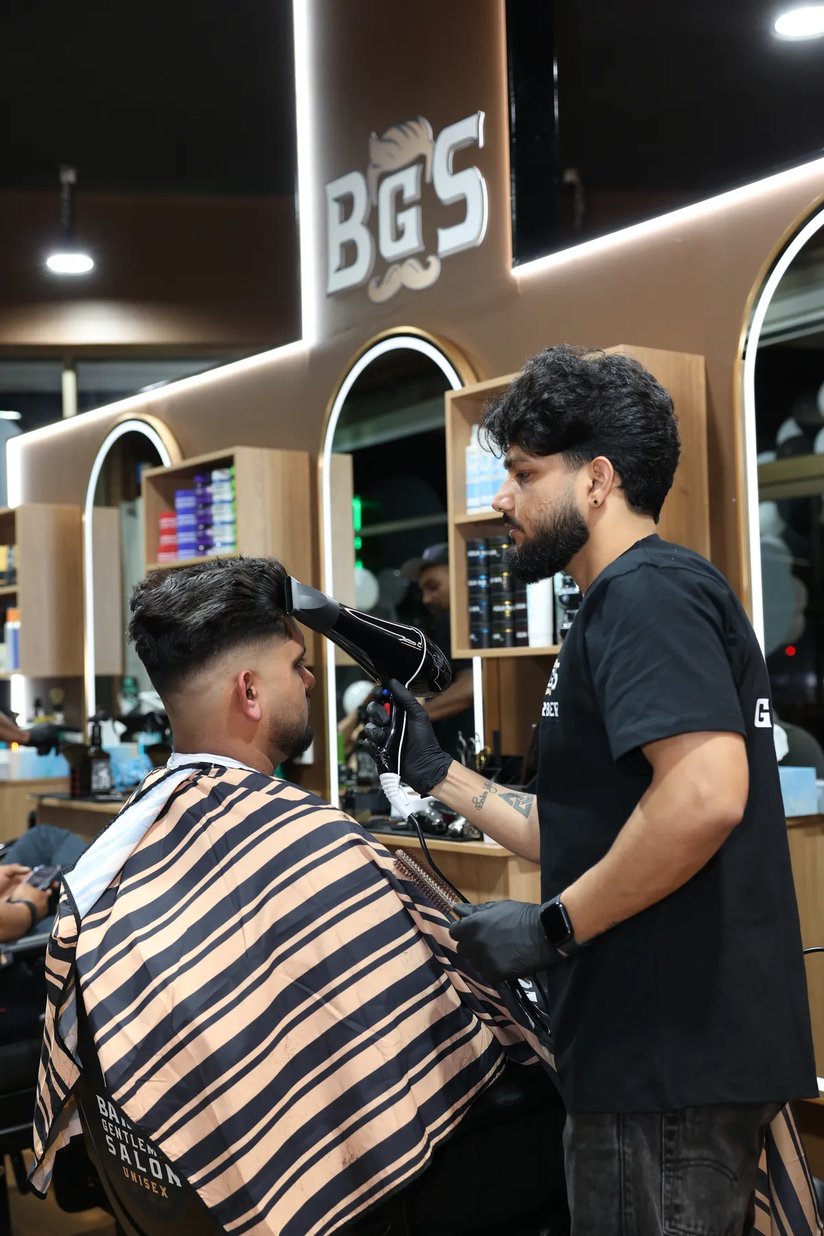 An artist shaping a client's haircut