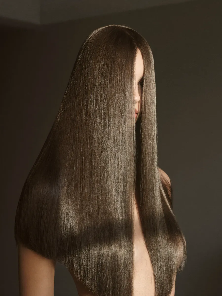 A smoothing treatment being combed through a client's hair